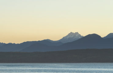 Couple kayaking in the Hood canal with Olympic National Park in