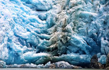 DWARFED BY MASSIVE GLACIER